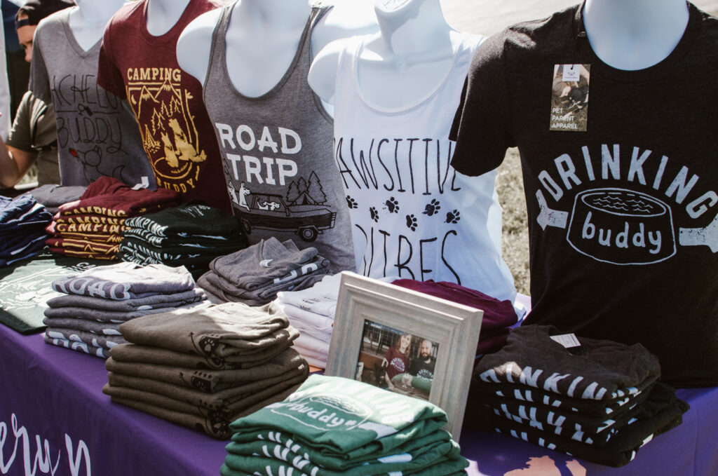 Merchandise spread out on table while selling at events traveling full time